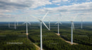 Aerial View of Wind Turbines in a Green Forest Landscape