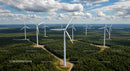 Aerial View of Wind Turbines Amidst Green Forest