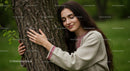 Woman Embracing Tree in Traditional Embroidered Dress