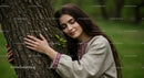 Woman Peacefully Embracing a Tree in Tranquil Forest