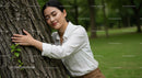 Woman Embracing Tree in Peaceful Green Park