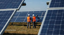 Engineers Inspecting Solar Panels on a Sunny Day