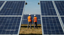 Engineers Inspecting Solar Panels on a Sunny Day
