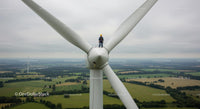 Engineer Maintaining Wind Turbine on Rural Wind Farm