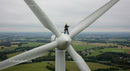 Technician Working on Wind Turbine Amidst Scenic Landscape
