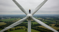 Engineer Maintaining Wind Turbine at High Altitude