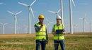 Engineers Inspecting Wind Turbines at Renewable Energy Farm