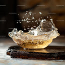 Dynamic Water Splash in Glass Bowl on Wooden Surface