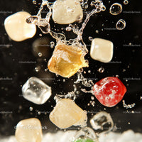 Vibrant Colored Ice Cubes Splashing in Water