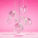 Floating Glass Spheres on Pink Background