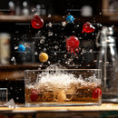 Colorful Balls Splashing in a Glass of Beverage