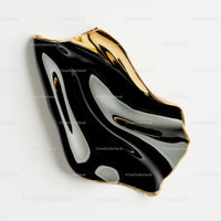Abstract Black and Gold Sculpture with Fluid Design