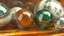 Colorful Glass Spheres on Wooden Surface