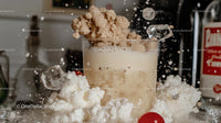 Creamy Cocktail Splashing with Ice and Sugar in a Glass