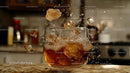 Dynamic Splash of Whiskey and Ice Cubes in Glass