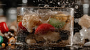 Vibrant Cocktail with Ice and Fruit Garnish in Glass