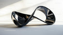 Sleek Black Modern Abstract Sculpture in Sunlight