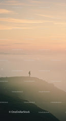 Silhouette of a Person on Mountain at Sunset