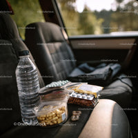 Travel Essentials with Snacks and First Aid Kit in Car