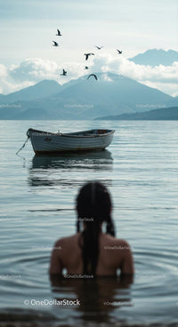 Peaceful Lake View with Boat and Mountains in the Distance