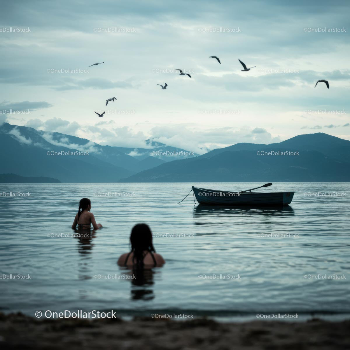 Tranquil Lake with Swimmers and Rowboat Amidst Mountains