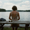 Woman Relaxing by the Tranquil Lakeside in Summer