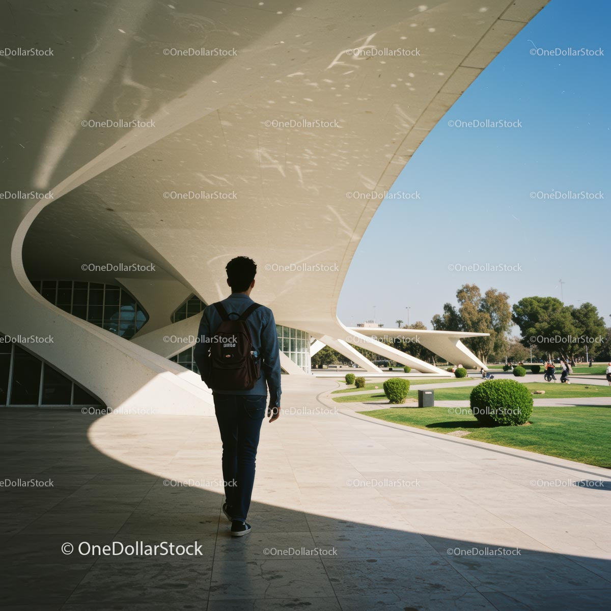 Man Walking Near Futuristic White Architectural Structure