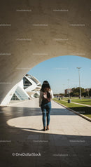 Woman Exploring Modern Architecture on a Sunny Day