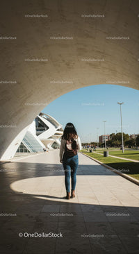 Woman Exploring Modern Architecture on a Sunny Day