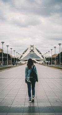Woman Exploring Modern Architecture on a Cloudy Day