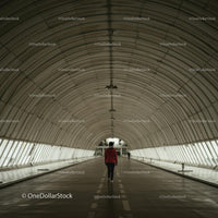 Person Walking Through Modern Arched Tunnel
