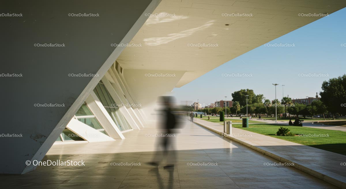 Pedestrians Near Futuristic Architecture in Urban Park