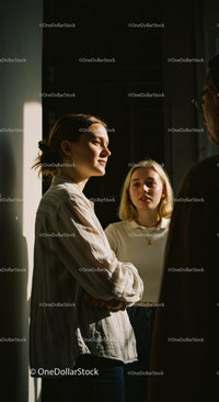 Sunlit Conversation Among Friends Indoors