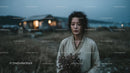 Pensive Woman Holding Yellow Wildflowers at Dusk