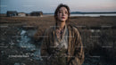 Pensive Woman Holding Yellow Wildflowers at Dusk