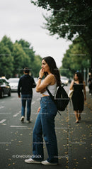 Young Woman in Casual Jeans Waiting on City Street