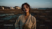 Pensive Woman Holding Yellow Wildflowers at Dusk