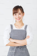 Smiling Woman in Gingham Dress with Arms Crossed