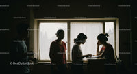 Silhouettes in Discussion by Sunlit Window