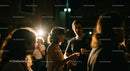 Young Adults Socializing at Nighttime Gathering