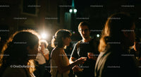 Young Adults Socializing at Nighttime Gathering