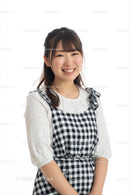 Smiling Woman in Checkered Dress on White Background