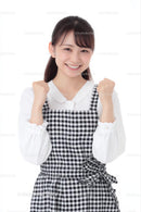 Smiling Woman in Black and White Plaid Dress