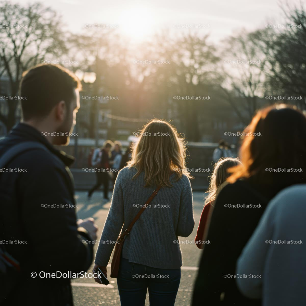 People Walking in Sunlit Urban Park