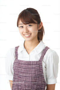 Smiling Woman in Casual Plaid Dress on Clean Background