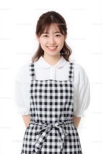 Smiling Young Woman in Black and White Checkered Dress