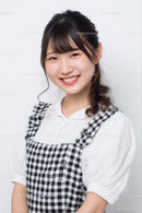 Smiling Woman in Plaid Dress with Bright Expression