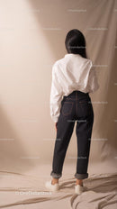 Woman in White Shirt and Denim Jeans in Minimalist Style
