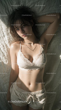 Woman Relaxing in Cozy Bedroom Setting with Natural Light