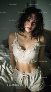 Young Woman in Relaxed Pose in Cozy Bedroom Setting